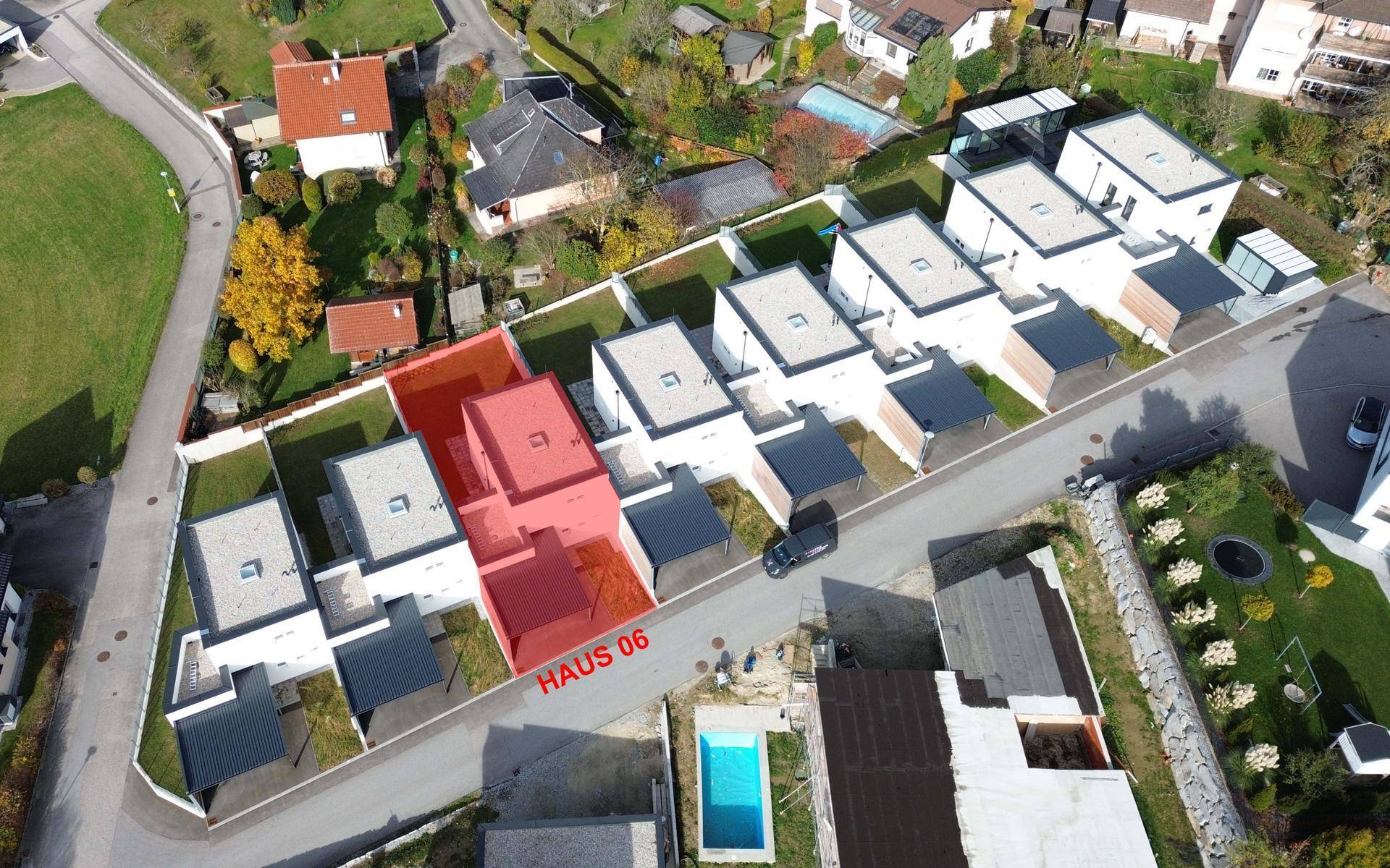 Übersicht der modernen Wohnanlage aus der Vogelperspektive mit markiertem Haus 06 und Carports.