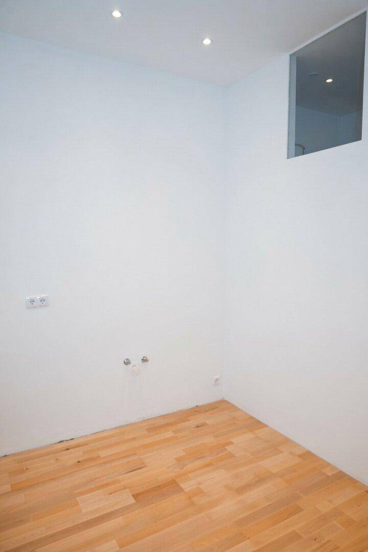 Kleiner Raum mit Parkettboden, Einbaustrahlern und einer oberen Fensteröffnung für zusätzliches Licht.