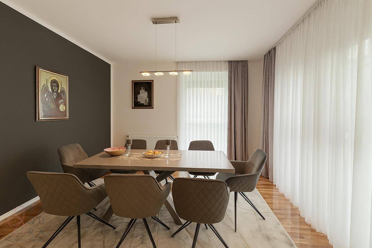 Eleganter Essbereich mit großem Tisch, bequemen Stühlen und viel Tageslicht.