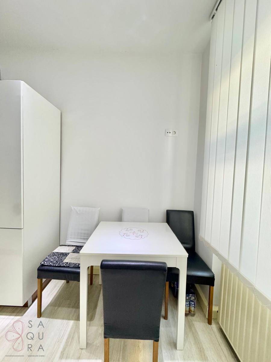 Heller Essbereich mit weißem Tisch und Sitzbank, ideal für Mahlzeiten in gemütlicher Atmosphäre.