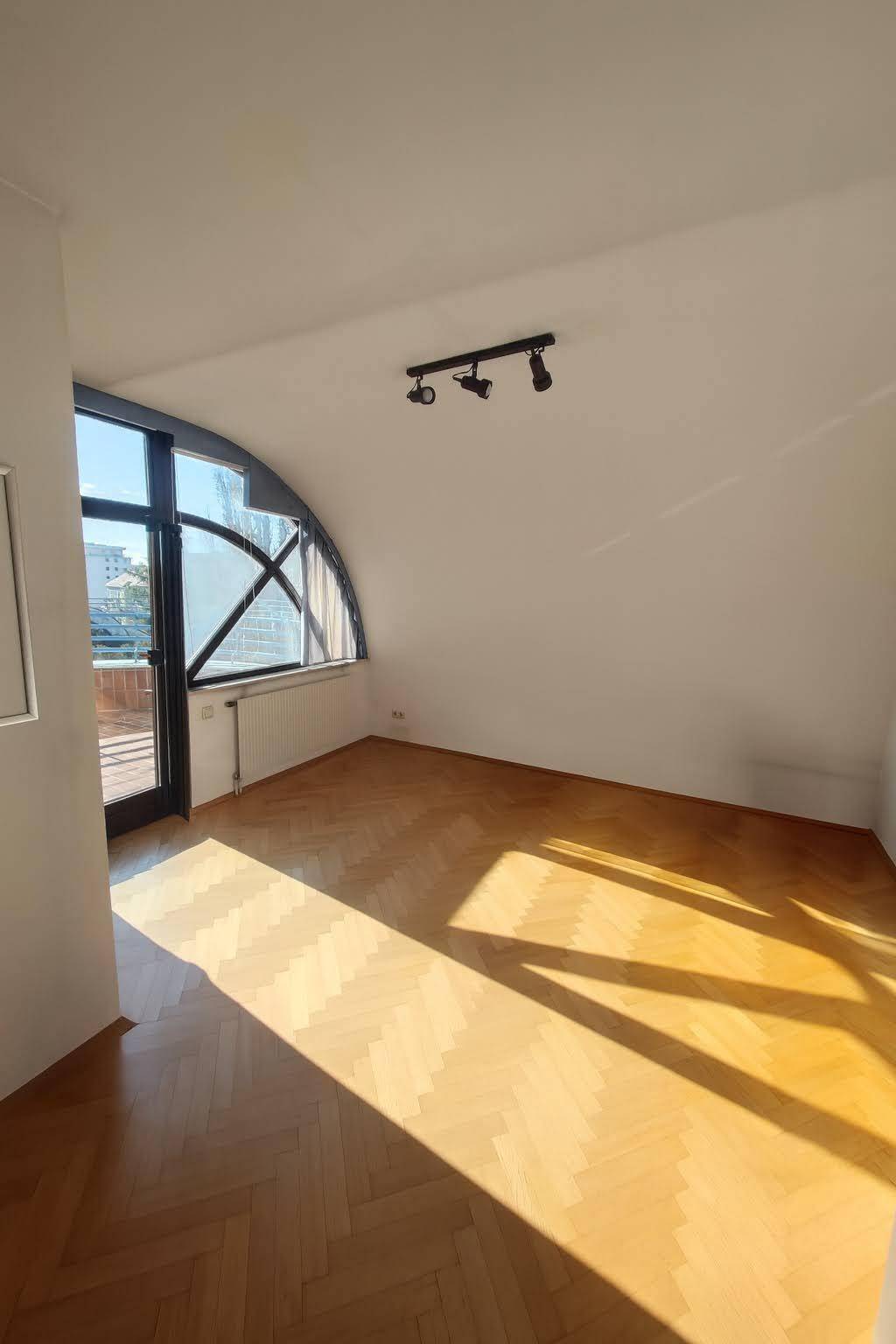 Helles Zimmer mit Parkettboden und direktem Zugang zur Dachterrasse, bietet vielseitige Nutzungsmöglichkeiten.
