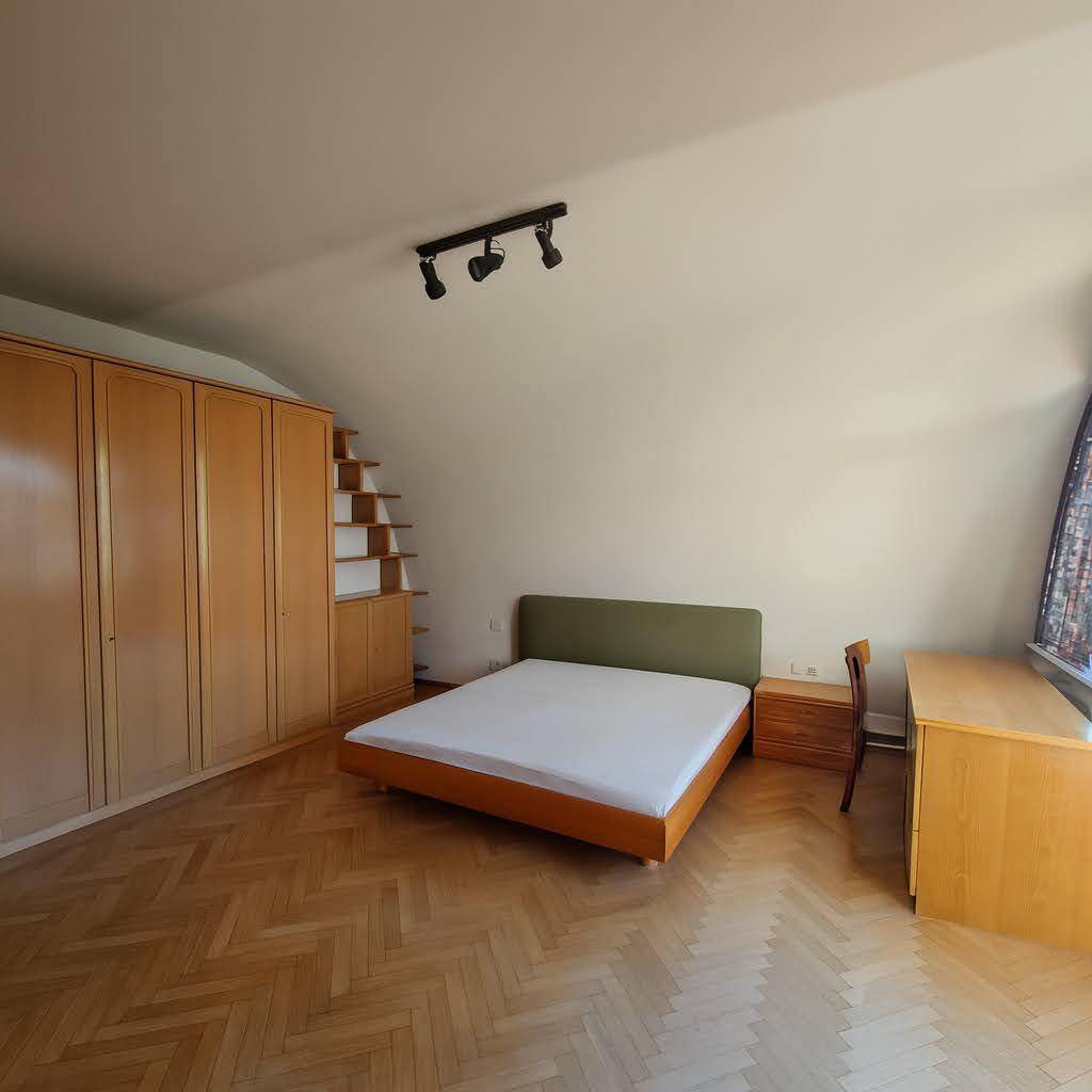 Geräumiges Schlafzimmer mit Parkettboden und Einbauschränken, bietet viel Stauraum und Komfort.