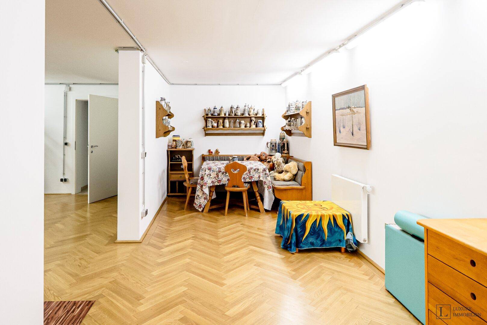Heller Essbereich mit Holzbänken, Tisch und Parkettboden, ideal für gesellige Runden.