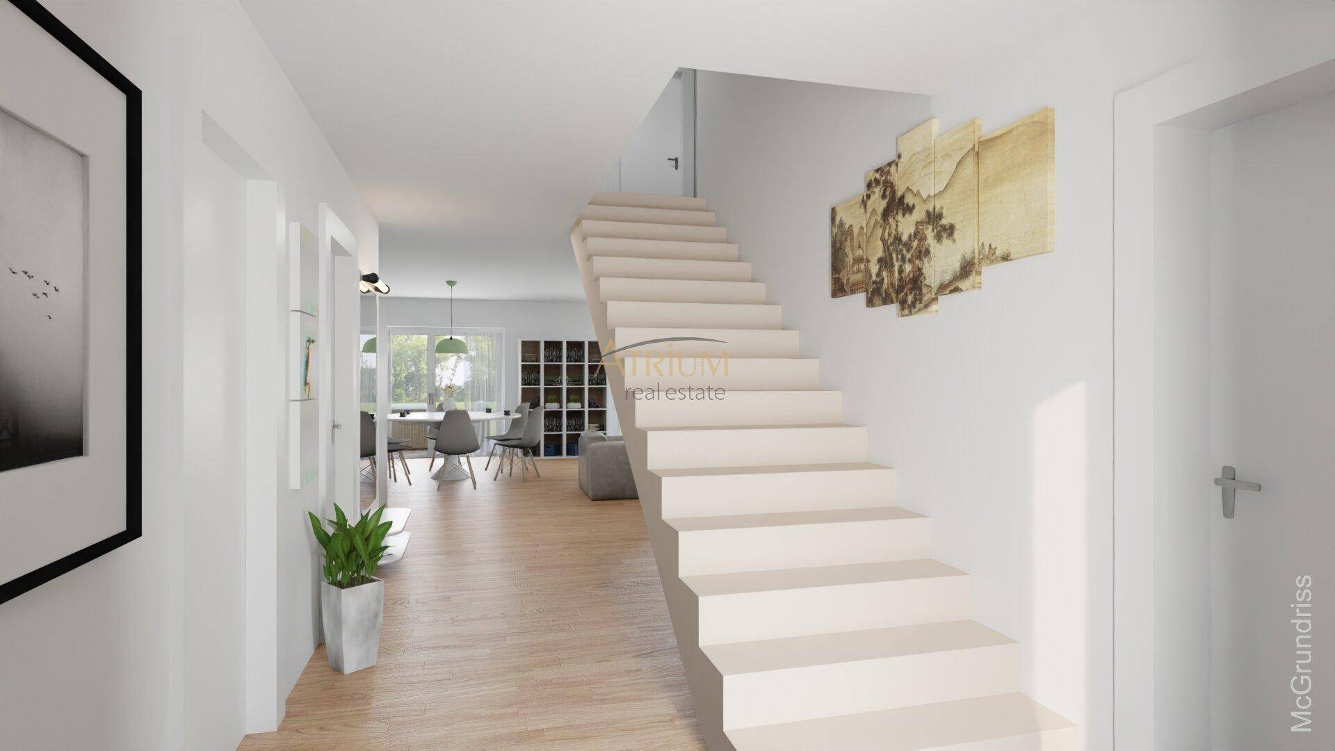 Heller Eingangsbereich mit moderner Treppe und Blick in den offenen Wohnbereich.