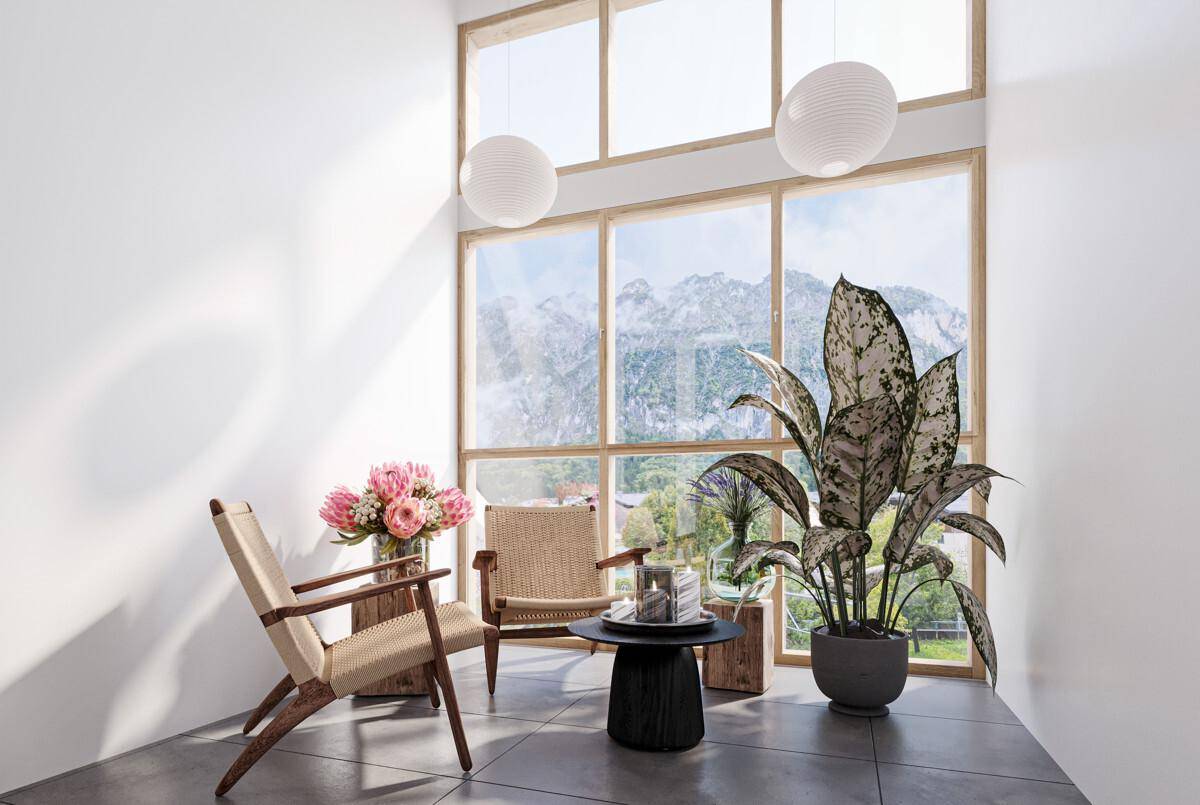 Gemütliche Sitzecke mit raumhohen Fenstern, die einen beeindruckenden Bergblick bieten.