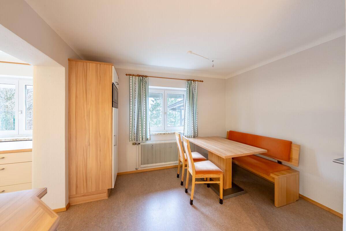 Gemütlicher Essbereich in der Küche mit Holztisch und Sitzbank, ideal für Familienmahlzeiten.