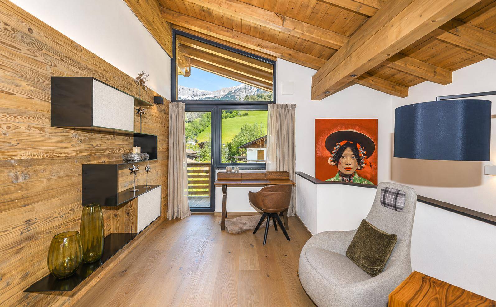 Heller Arbeitsbereich mit Holzwänden, Schreibtisch und Ausblick in die Natur.
