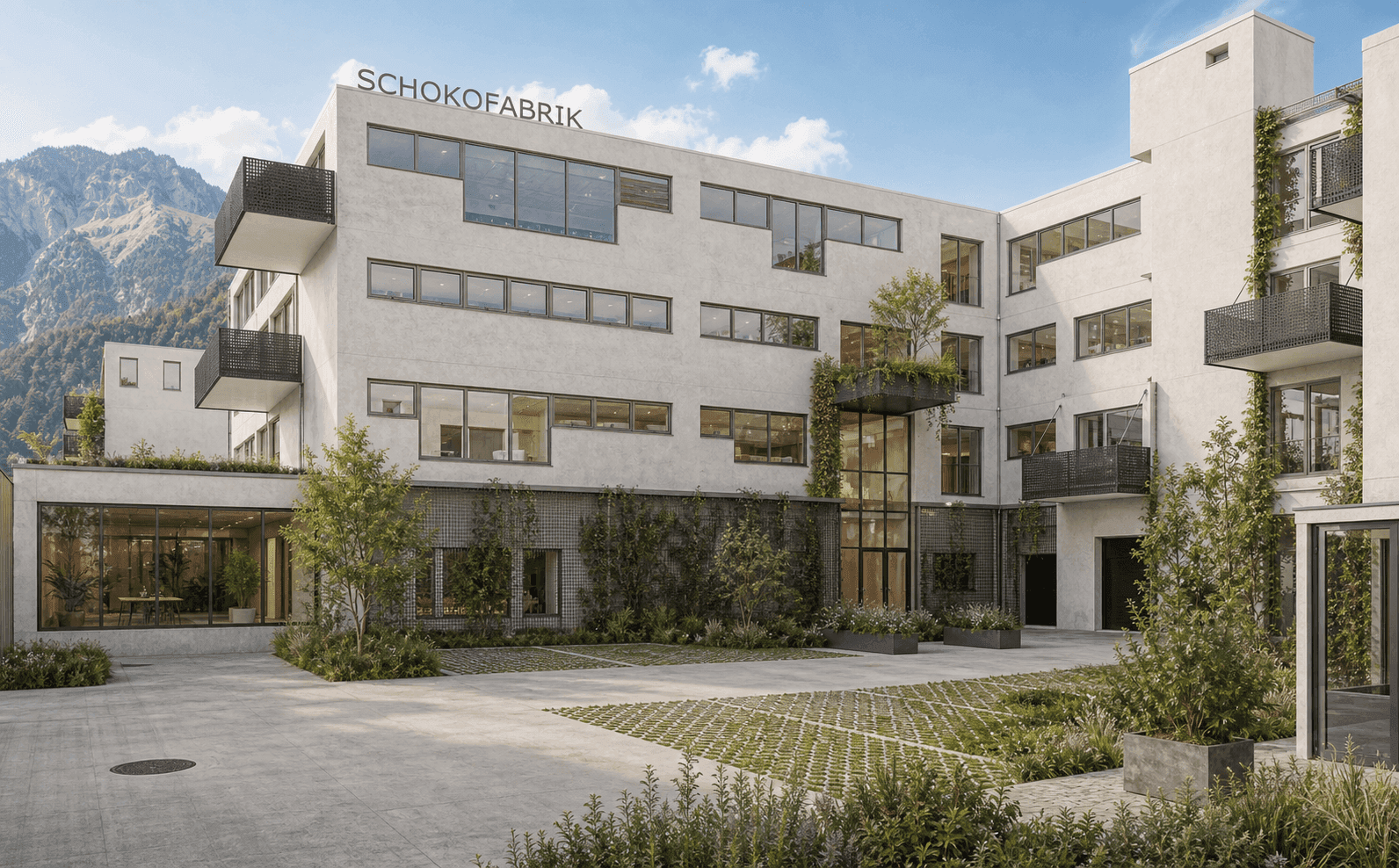 Großes, modernes Gebäude mit ansprechender Architektur, begrünten Fassaden und einem Innenhof.