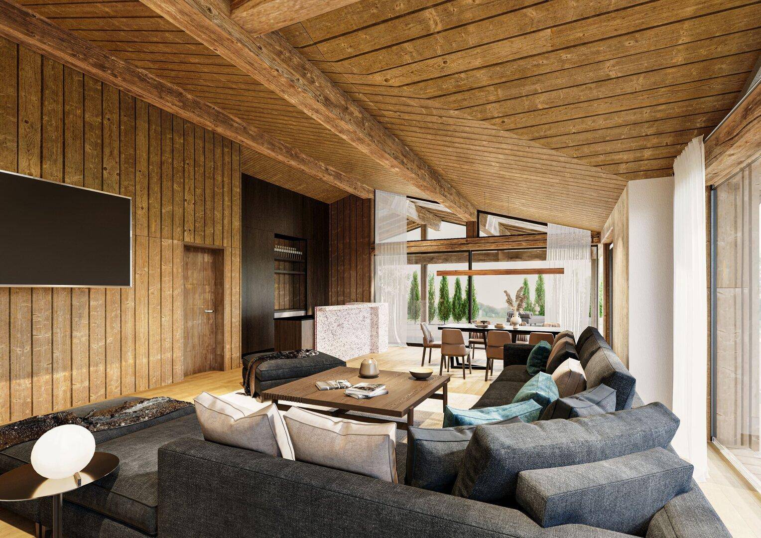 Gemütlicher Wohn-Essbereich mit Holzbalkendecke, großen Fenstern und modernem Sofa in warmen Tönen.