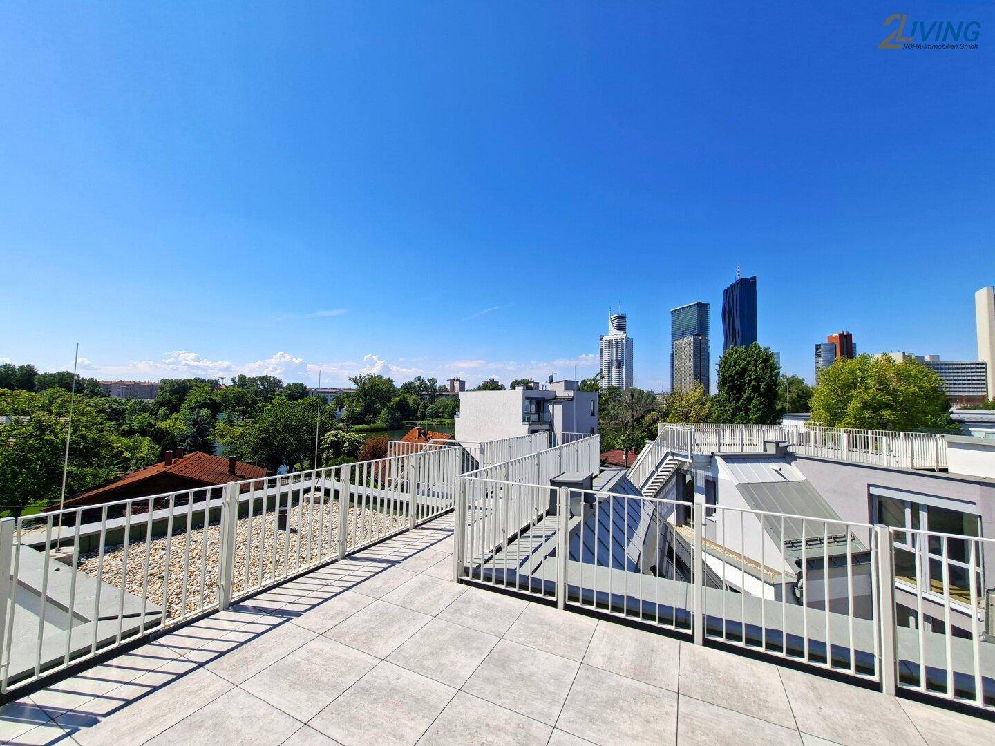 Weitläufige Dachterrasse mit modernen Geländern und beeindruckendem Panoramablick auf die Stadt.
