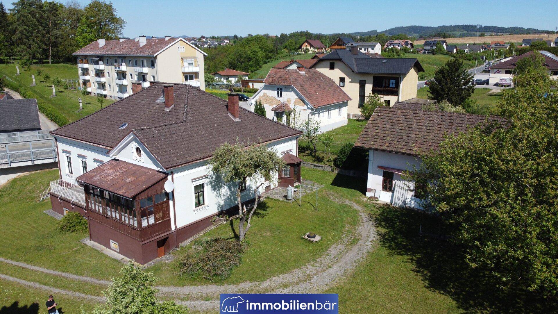 Weitläufige Ansicht des Wohnhauses mit großem Garten und umliegender Bebauung.