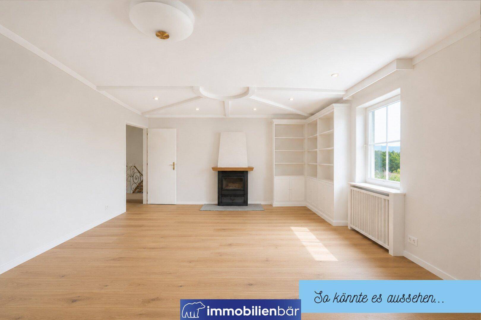 Helles, renoviertes Wohnzimmer mit modernem Kamin, Holzboden und Blick ins Grüne.