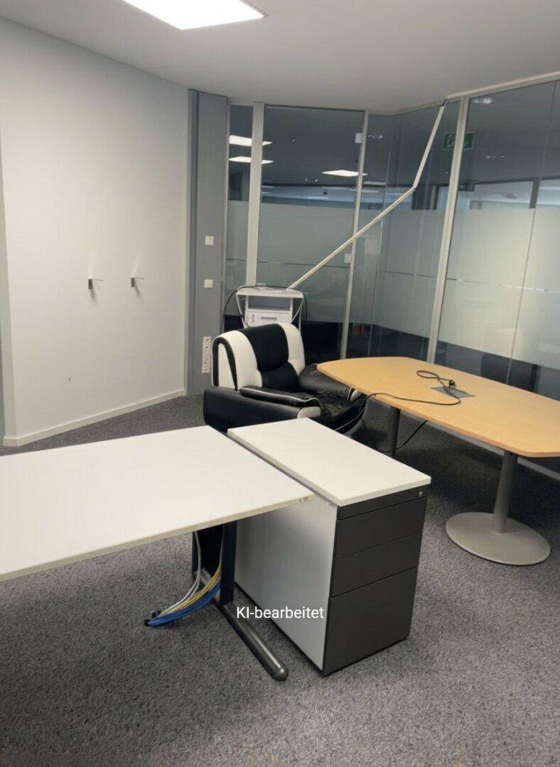 Büroraum mit einem Schreibtisch, einem ergonomischen Stuhl und einem Drucker.