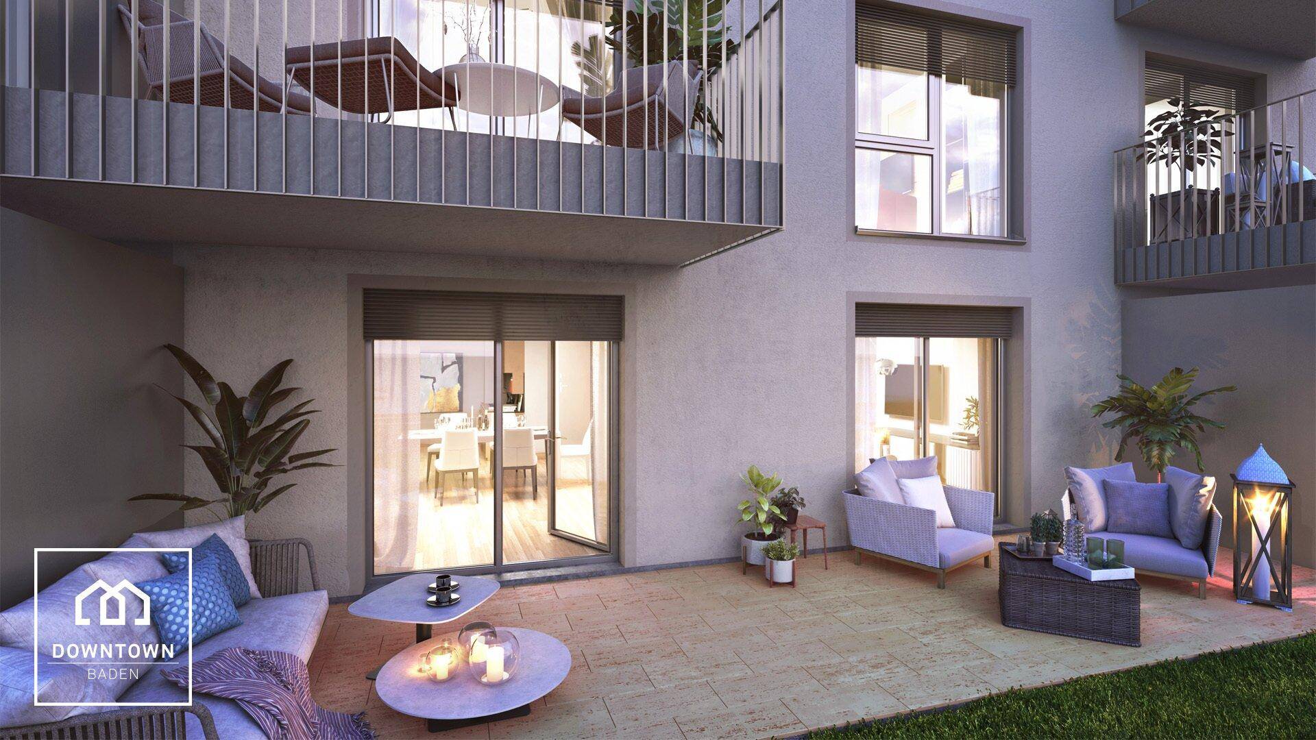 Gemütliche Terrasse im Erdgeschoss mit Loungemöbeln und Blick auf den Gartenbereich.