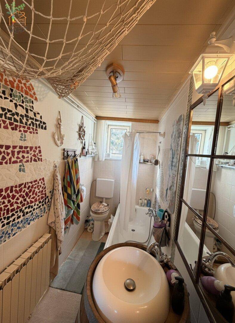 Individuell gestaltetes Badezimmer mit Fasswaschbecken, Badewanne und farbenfroher Wanddekoration.