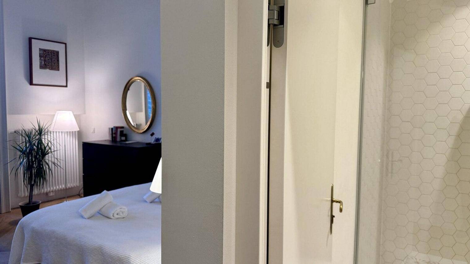 Schlafzimmer mit Blick auf den Eingang zum modernen Badezimmer.
