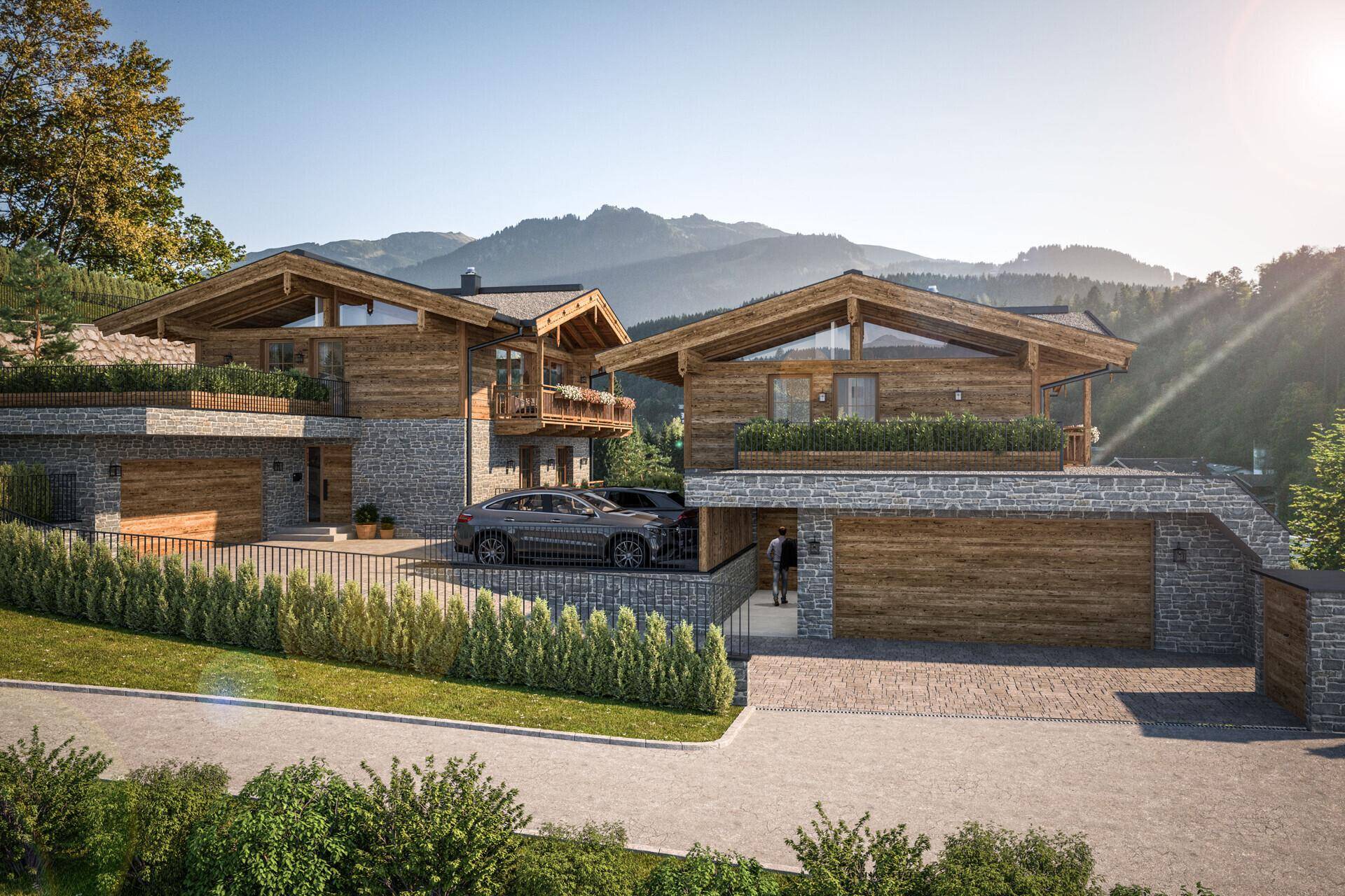 Moderne Chalets mit Holz- und Steinfassade, integrierten Garagen und Bergblick in sonniger Lage.
