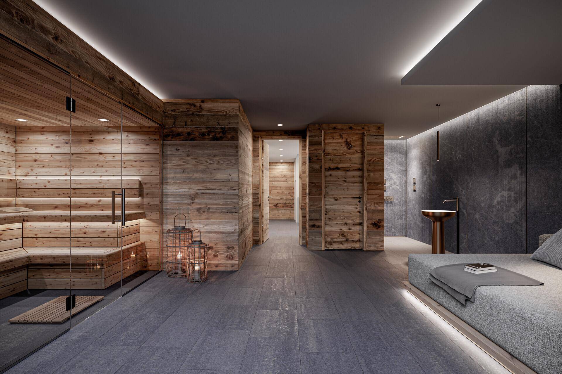 Exklusiver Wellnessbereich mit Sauna, dunklem Fliesenboden und einer eleganten Liegefläche.