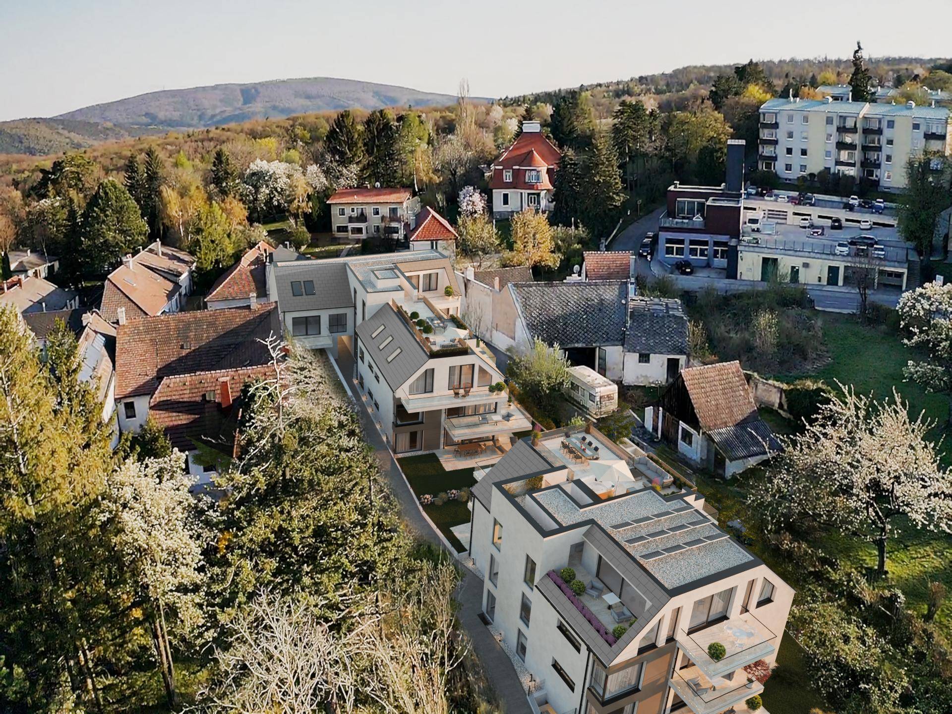 Luftaufnahme einer Wohnsiedlung mit neuen Gebäuden und grüner Umgebung.