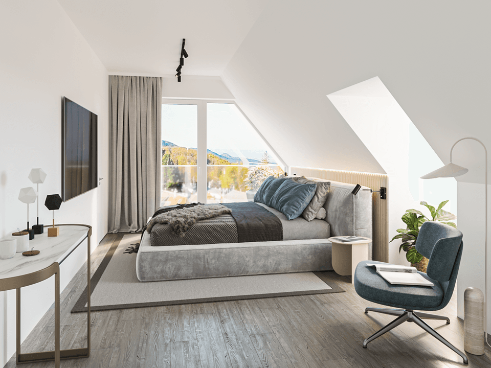 Gemütliches Schlafzimmer im Dachgeschoss mit schrägen Wänden und malerischem Ausblick.