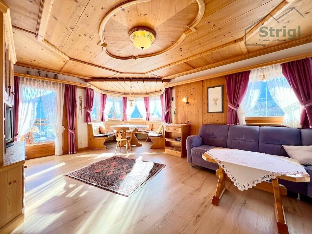 Gemütlicher Wohn-Essbereich im traditionellen Stil mit viel Holz, Eckbank und bequemer Sofagarnitur.