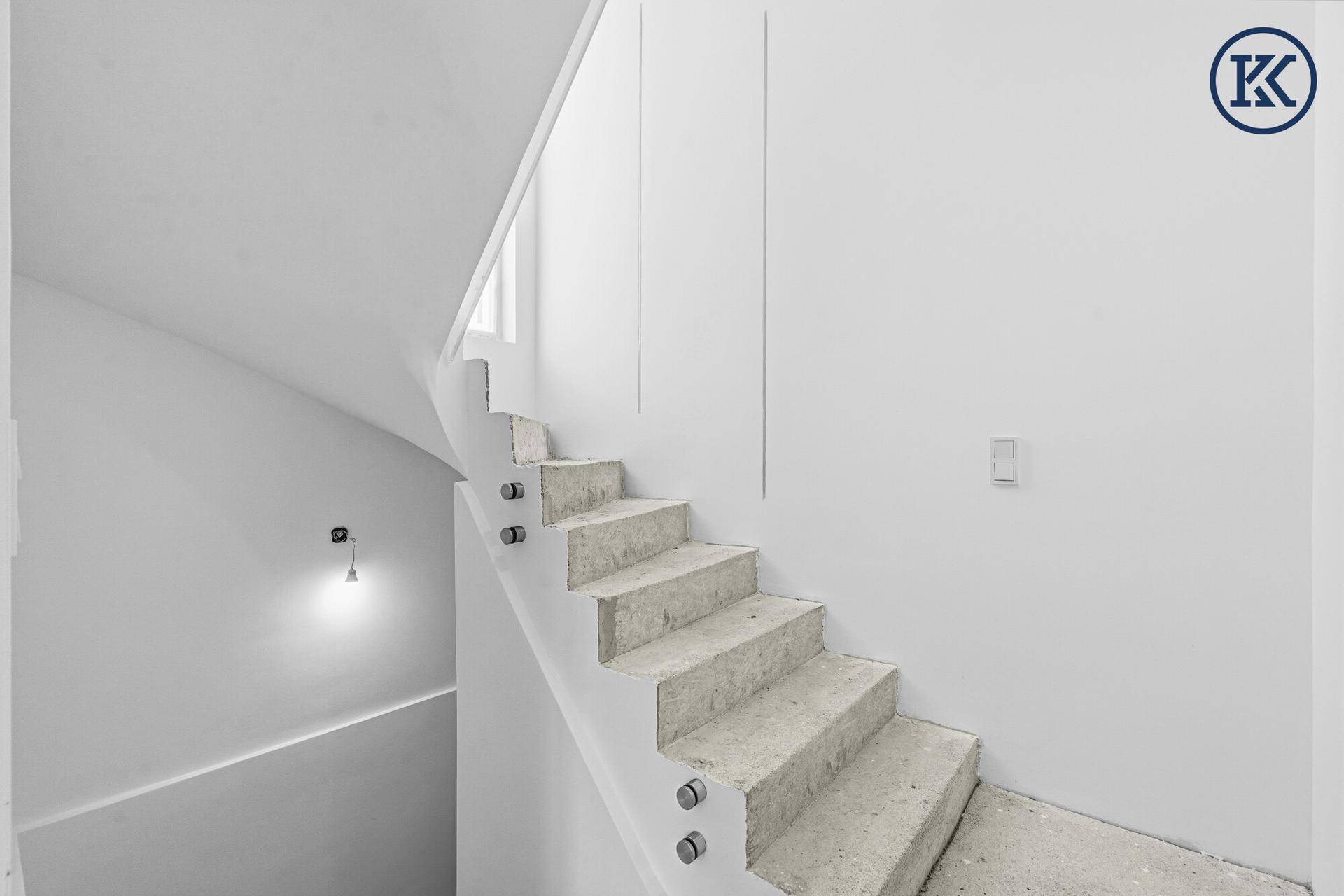Treppenaufgang im Rohbau mit Betonstufen und minimalistischem Design, bereit für die Fertigstellung.