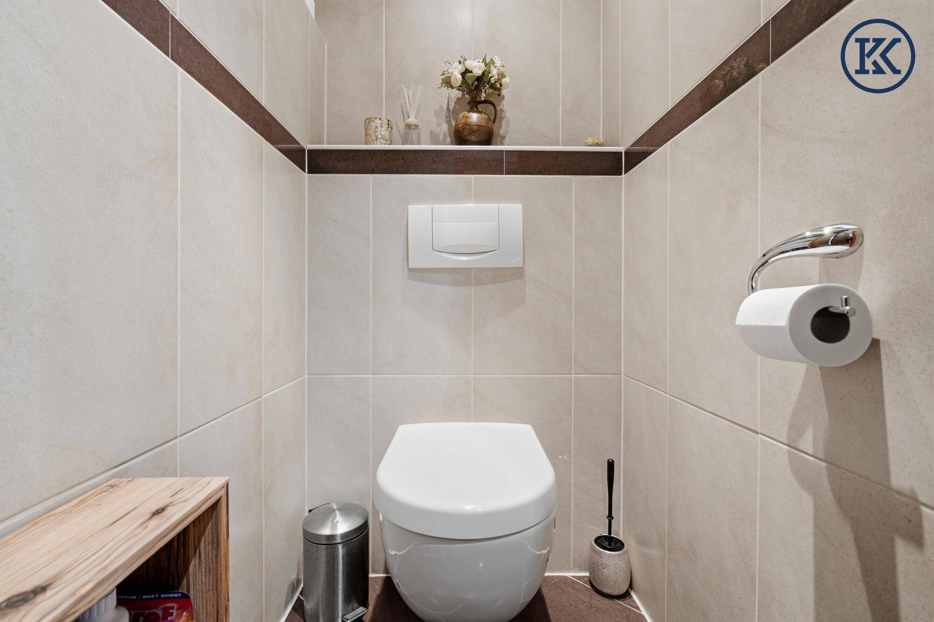 Modernes Gäste-WC mit wandhängender Toilette und eleganten Fliesen.