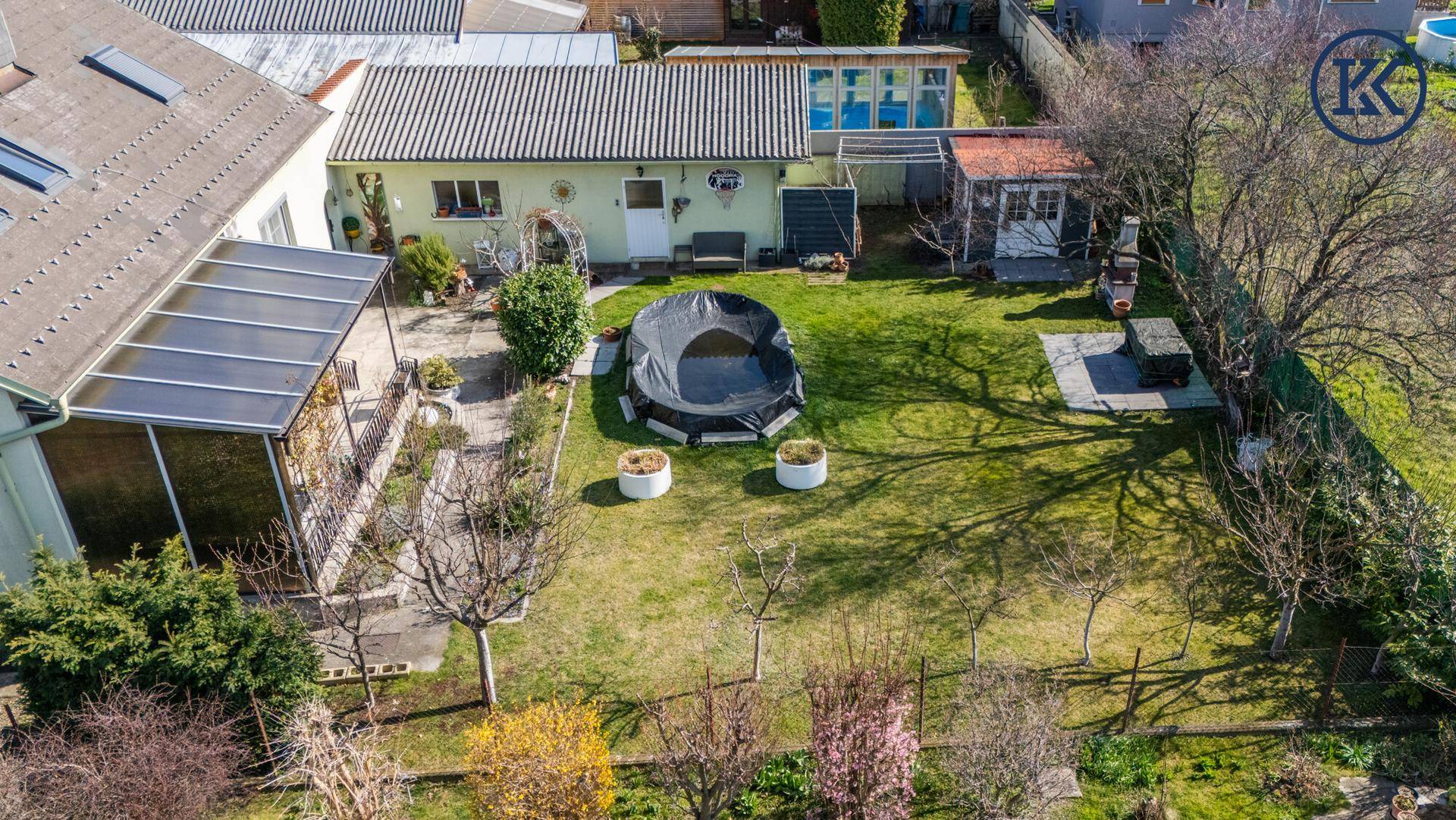 Vogelperspektive des Anwesens mit Haus, großem Garten und Poolbereich.
