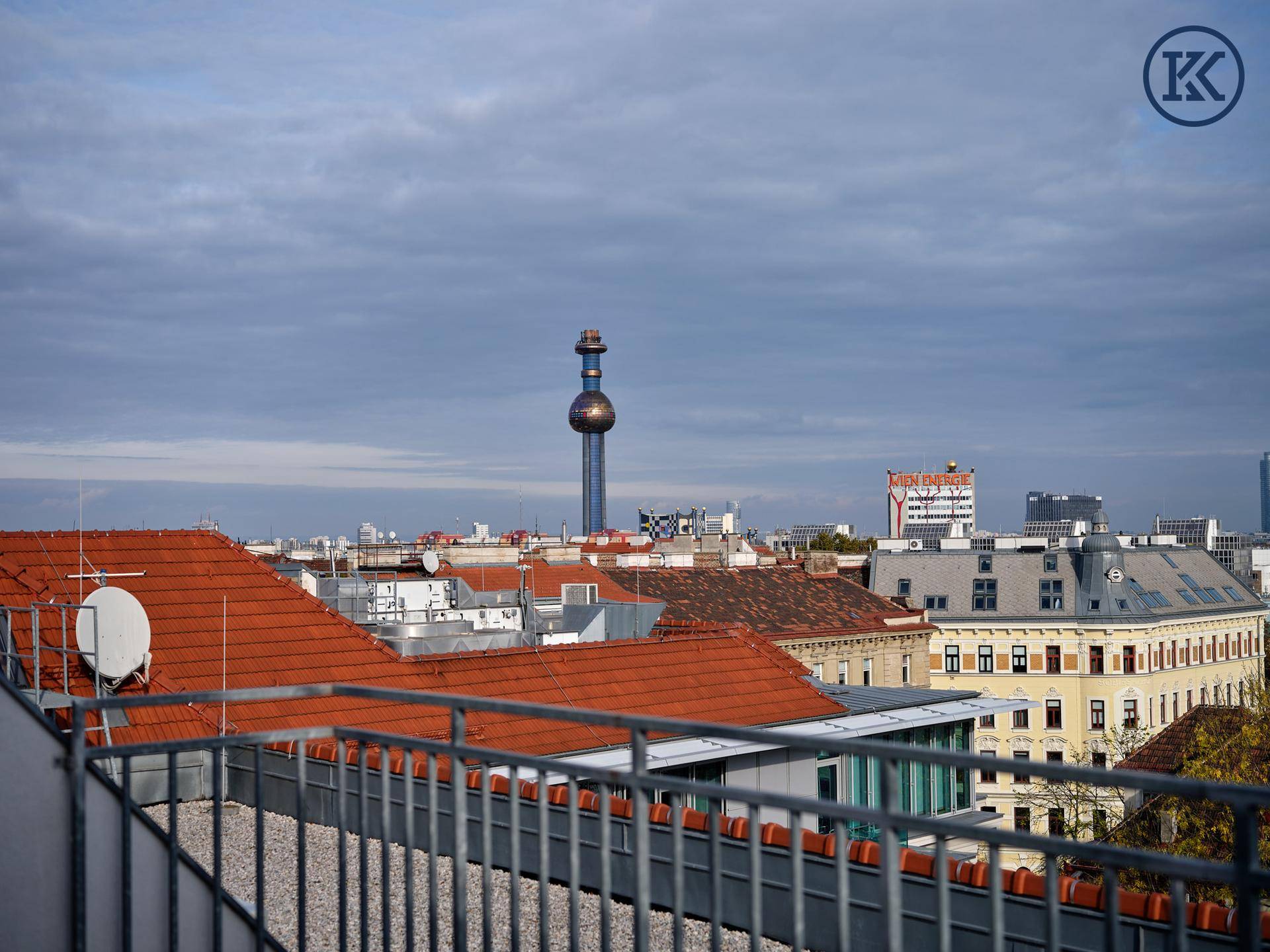 Panoramablick über die Stadt mit markanten Gebäuden und einem Fernsehturm am Horizont.