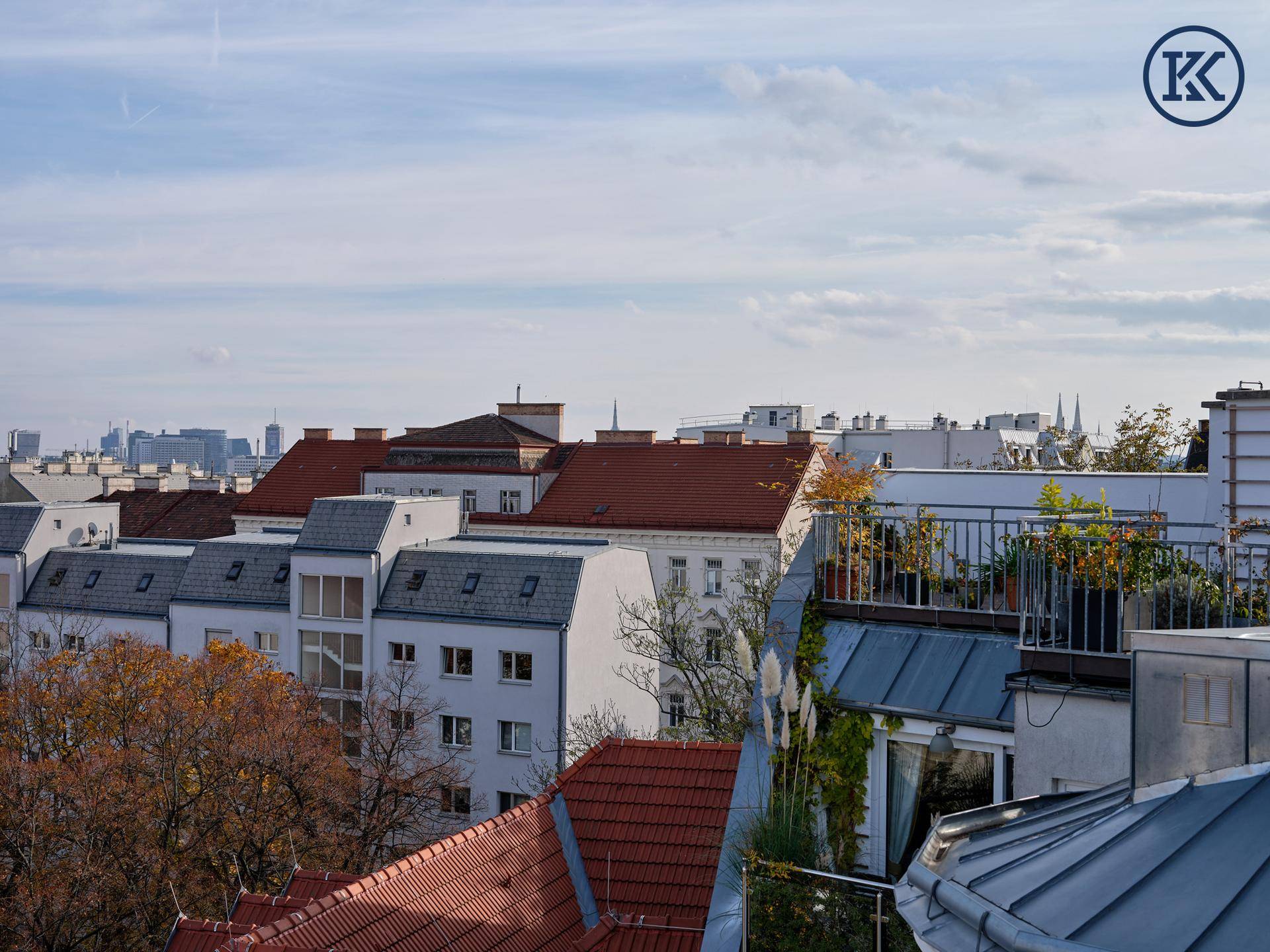 Stadtansicht mit einer Reihe von Gebäuden und einem begrünten Dachgarten im Vordergrund.