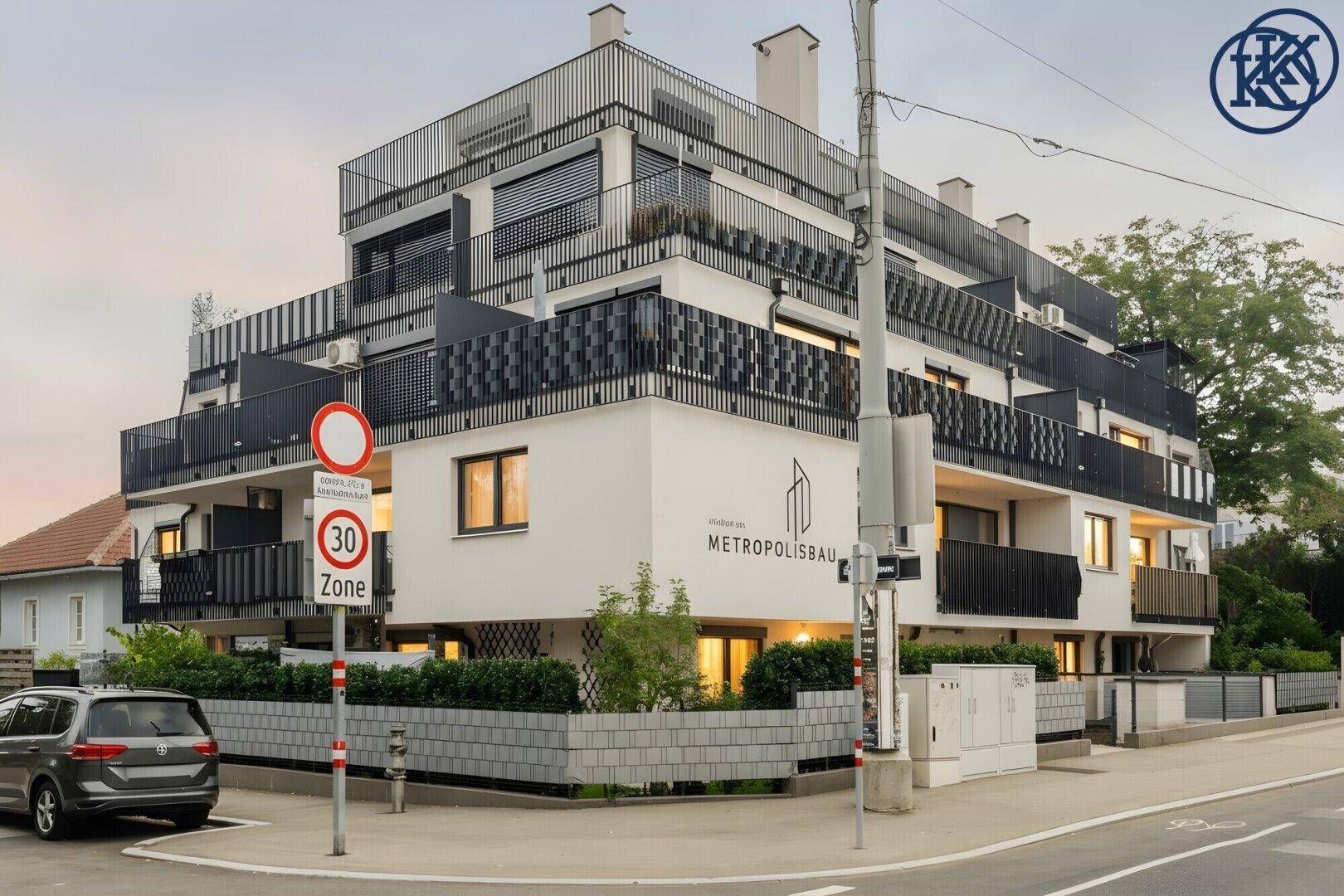Eckansicht des modernen Apartmentgebäudes mit markantem Design und "Metropolisbau"-Logo.