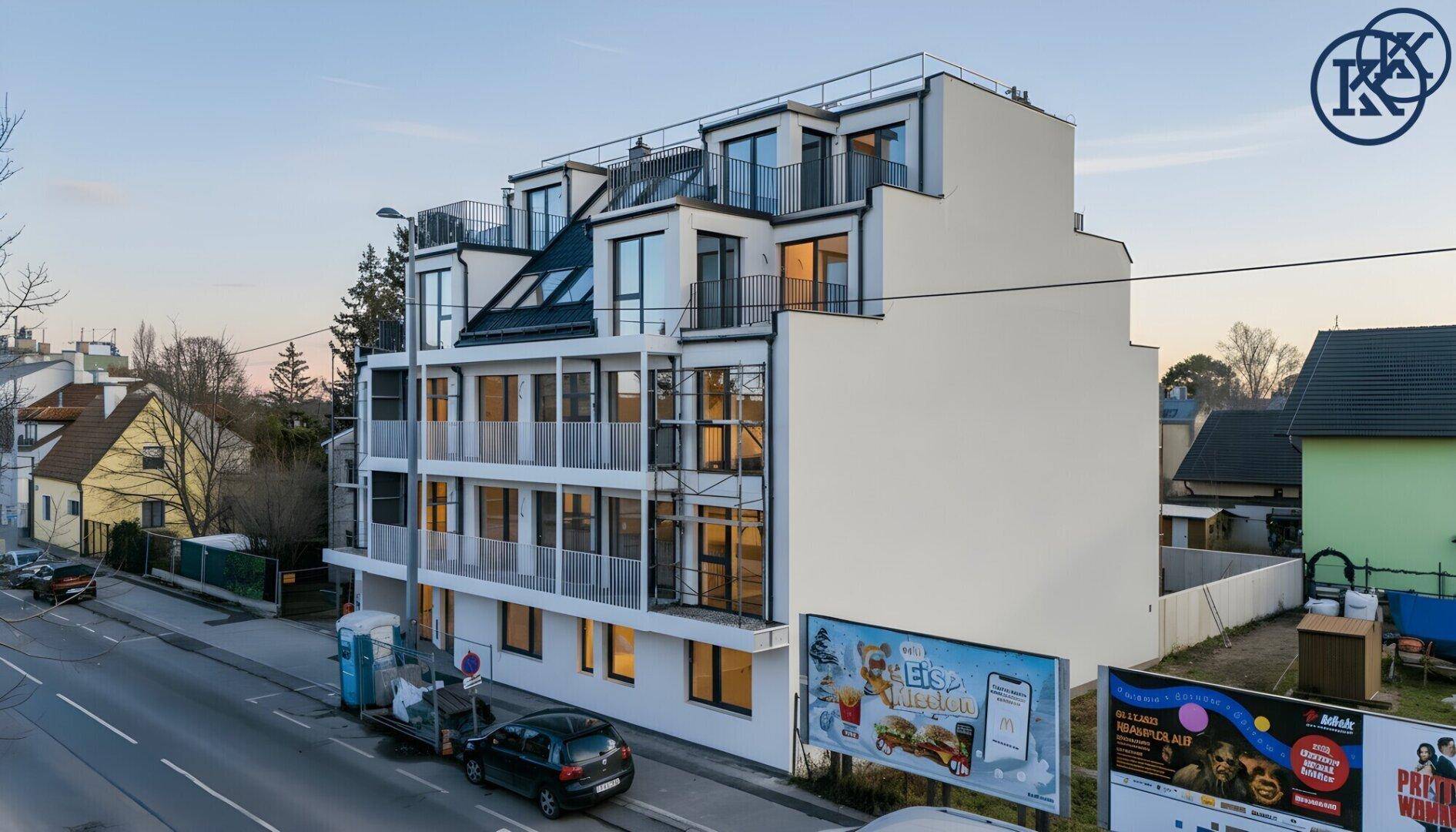 Modernes Wohngebäude an einer Straße mit Werbetafeln und parkenden Autos.