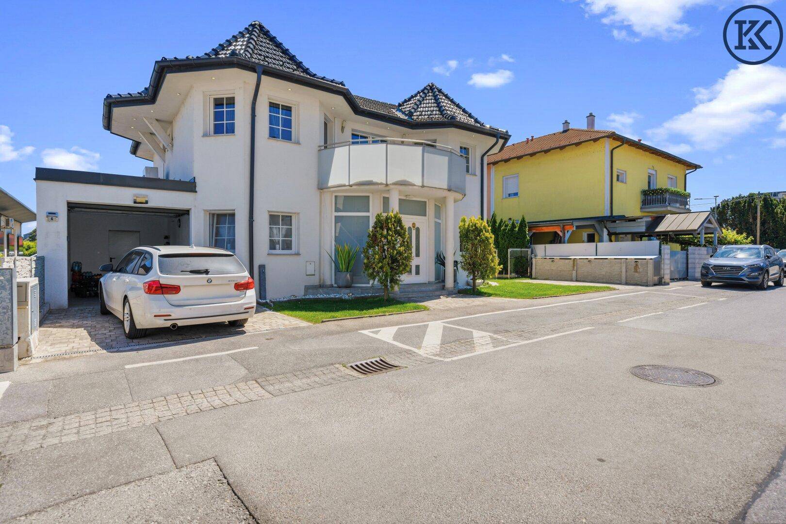 Attraktives Wohnhaus mit Doppelgarage, gepflegter Auffahrt und moderner Architektur.
