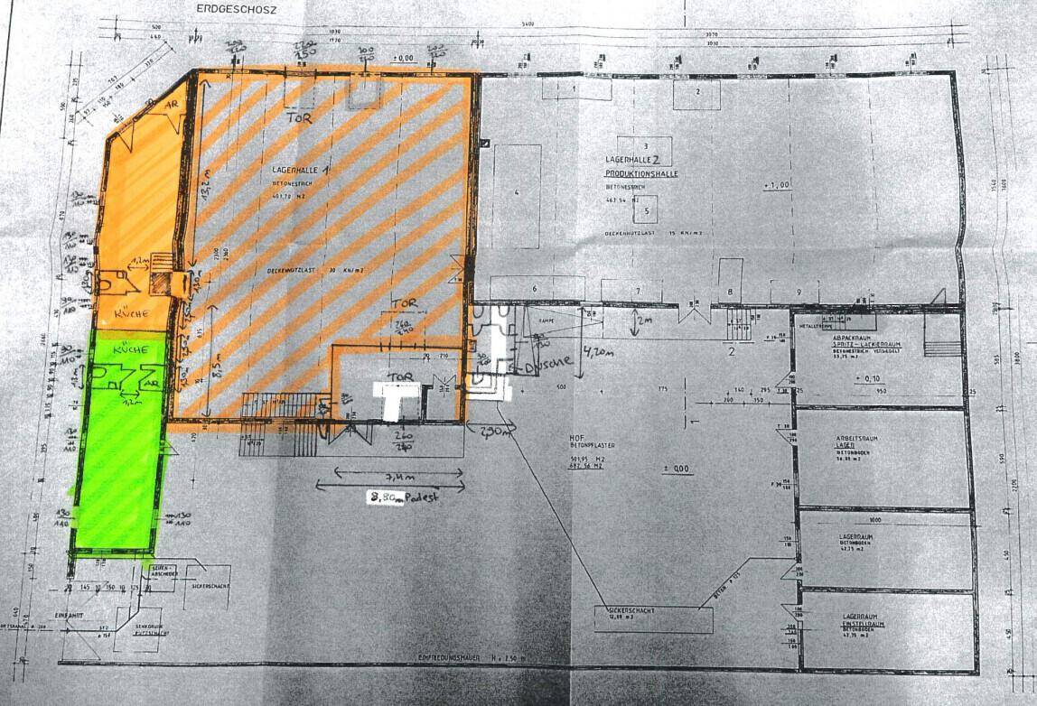 Grundriss des Erdgeschosses mit Lagerhallen, Büros und einer Küche, farblich markiert.