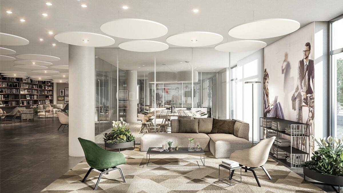 Einladender Loungebereich mit bequemen Sofas, Pflanzen und Blick auf einen weiteren Gemeinschaftsbereich.