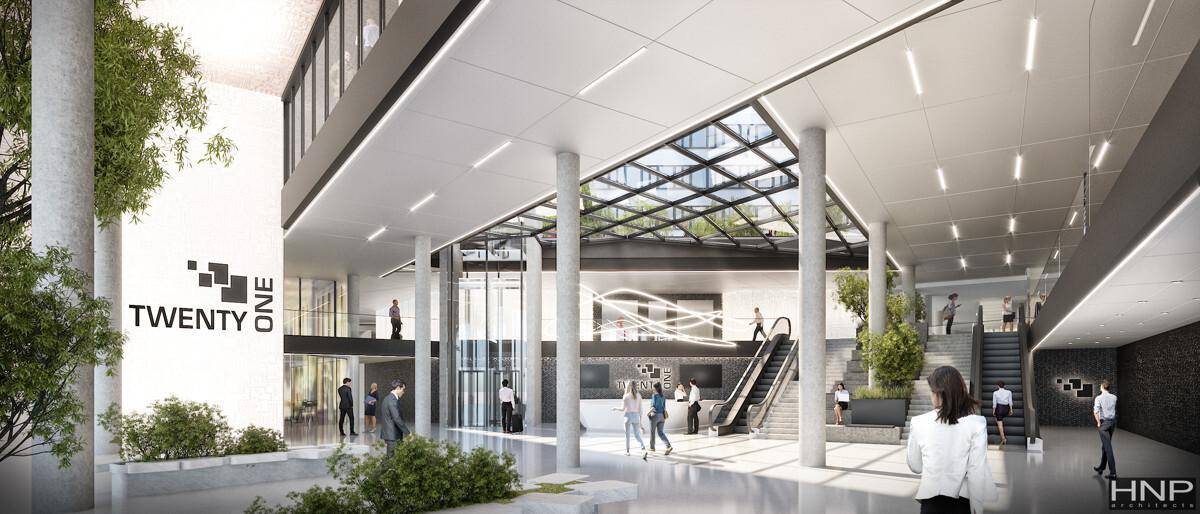 Großzügige, moderne Lobby mit hohen Decken, Glasdach und Rolltreppen, die viel Tageslicht hereinlässt.