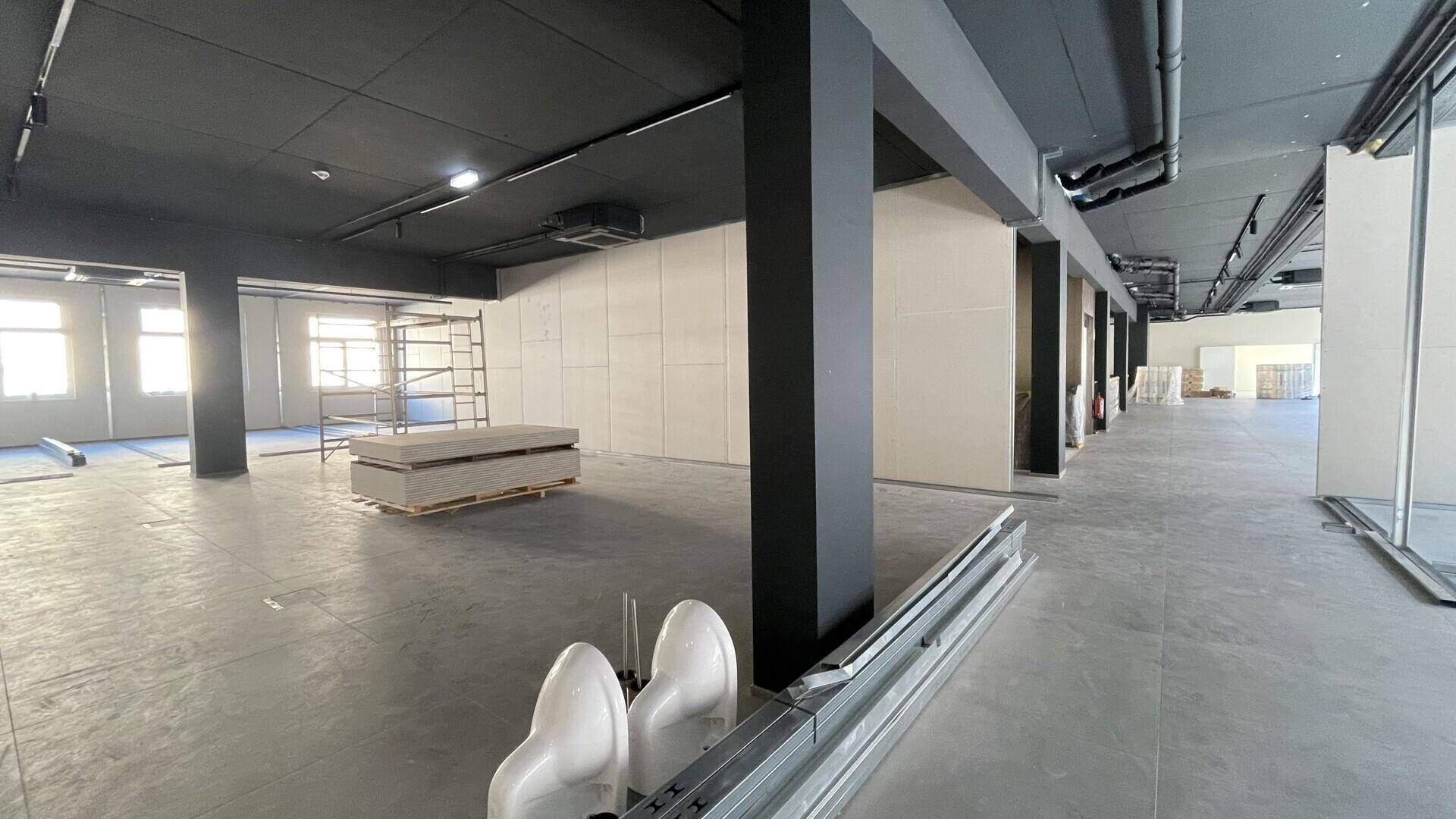 Obergeschoss eines Gewerberaums im Bau, mit Trockenbauwänden und sichtbaren Installationen.