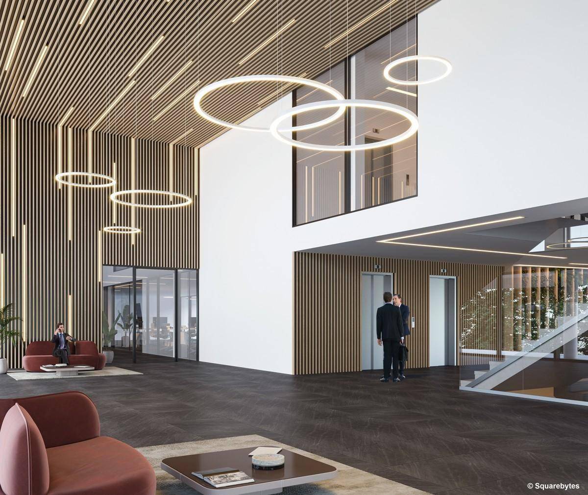 Elegante Lobby mit hohen Decken, modernen Leuchten und Aufzügen, einladend und stilvoll.
