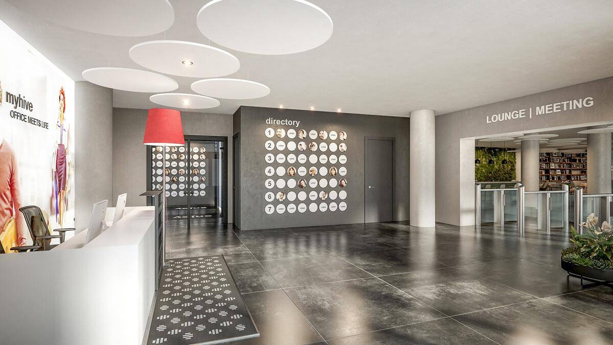 Moderne Empfangshalle mit minimalistischem Design, großen Fliesen und dekorativen Deckenpaneelen.