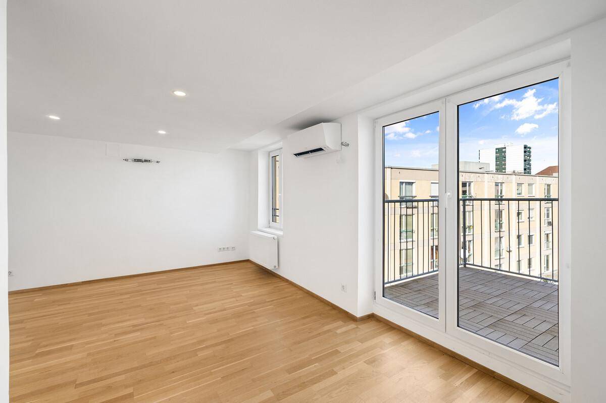 Geräumiger, heller Wohnbereich mit Holzboden und großem Fenster mit Blick auf die Stadt.
