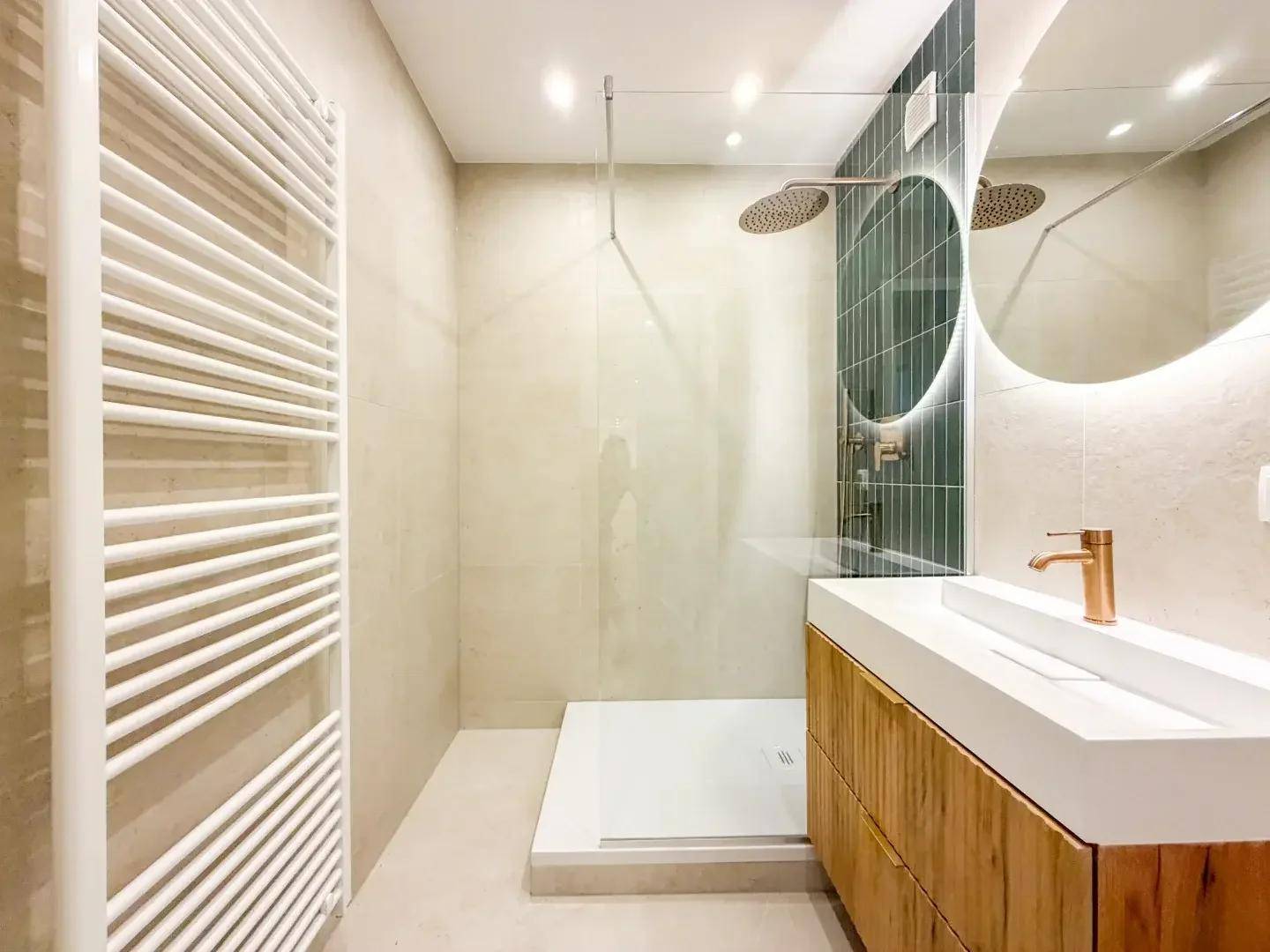 Modernes Badezimmer mit begehbarer Dusche, stilvollem Waschtisch und beheiztem Handtuchhalter.