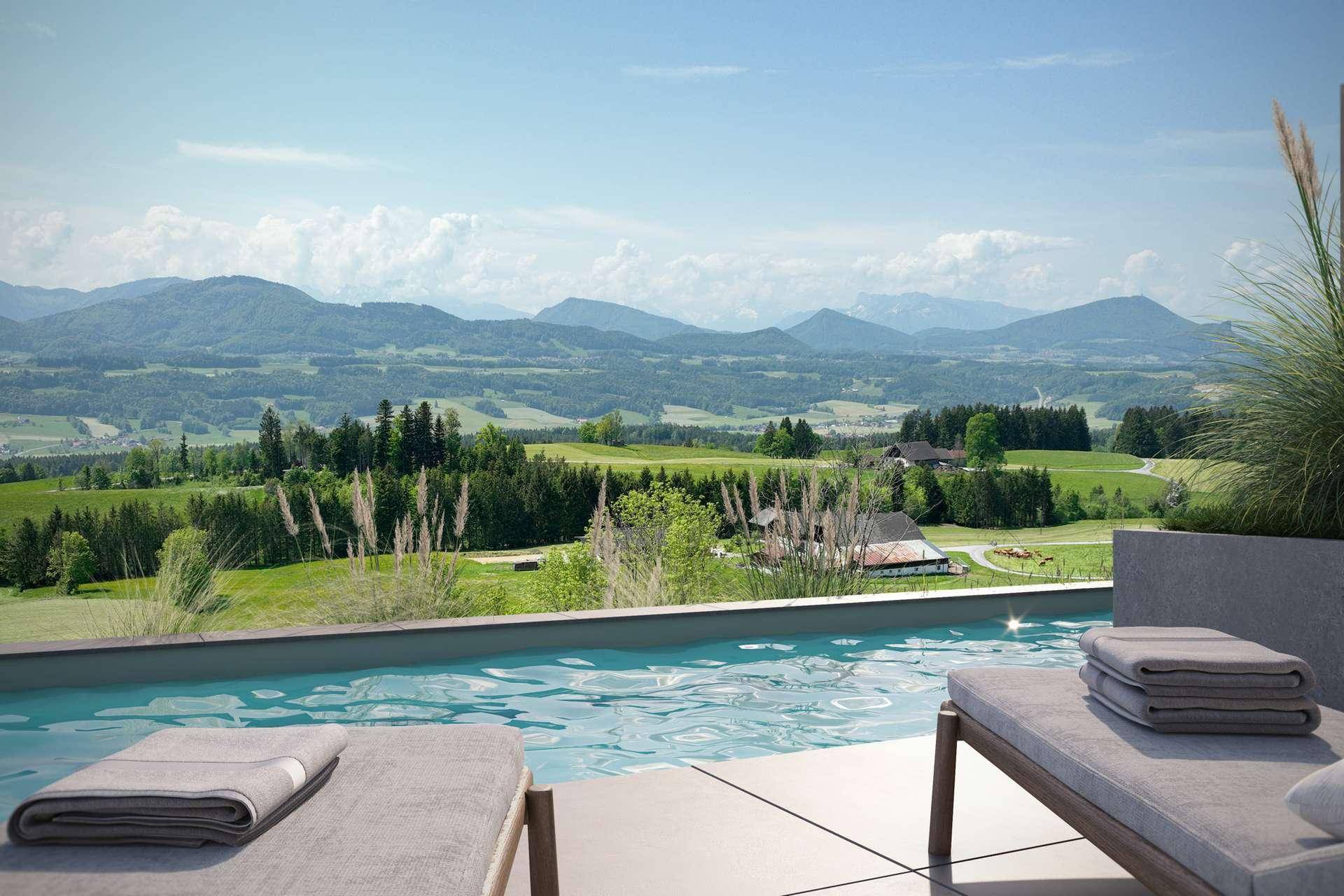 Infinity-Pool mit Liegestühlen und atemberaubendem Panoramablick auf Berge und grüne Landschaft.