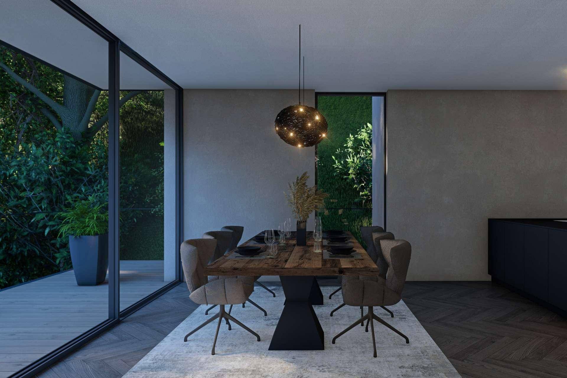Heller Essbereich mit Zugang zur Terrasse, umgeben von großen Glasfronten und Natur.