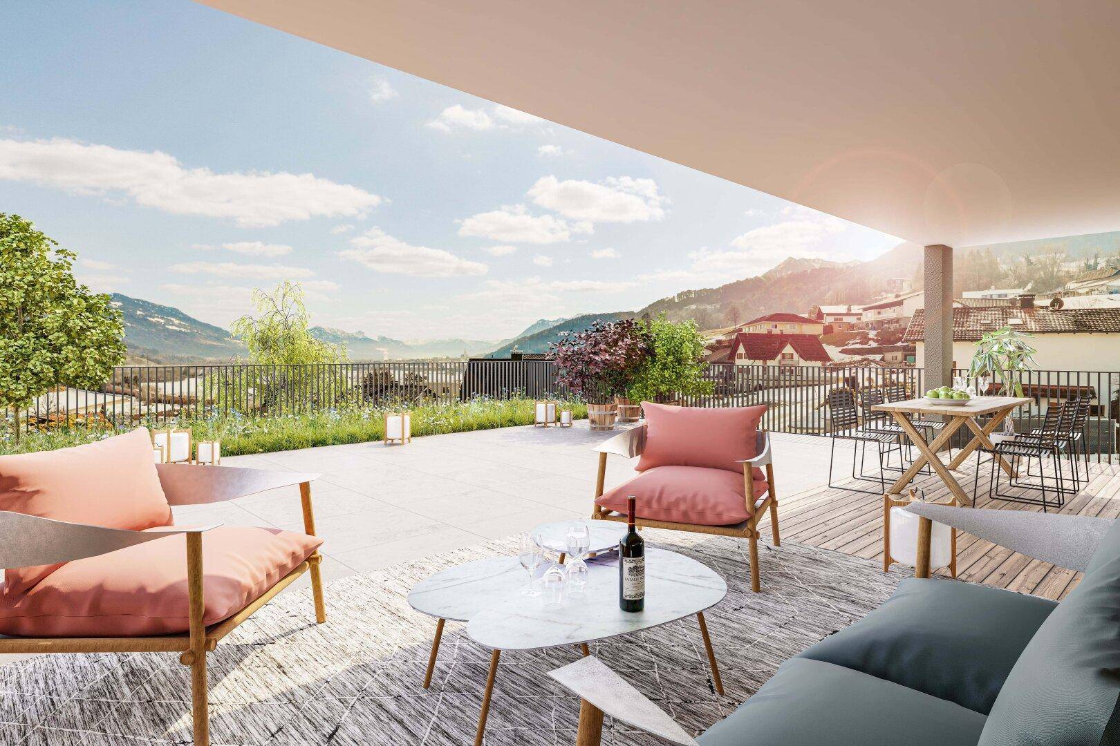 Geräumige Sonnenterrasse mit modernen Möbeln und Panoramablick auf die umliegende Landschaft und Berge.