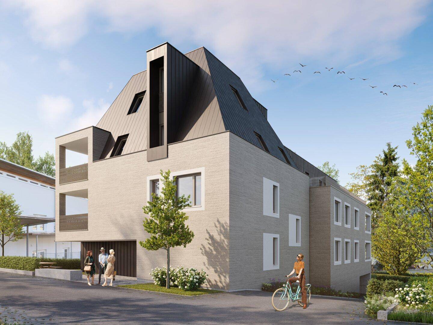 Moderne Fassade des Neubaus mit markantem Dach, großen Fenstern und Bäumen im Vordergrund.