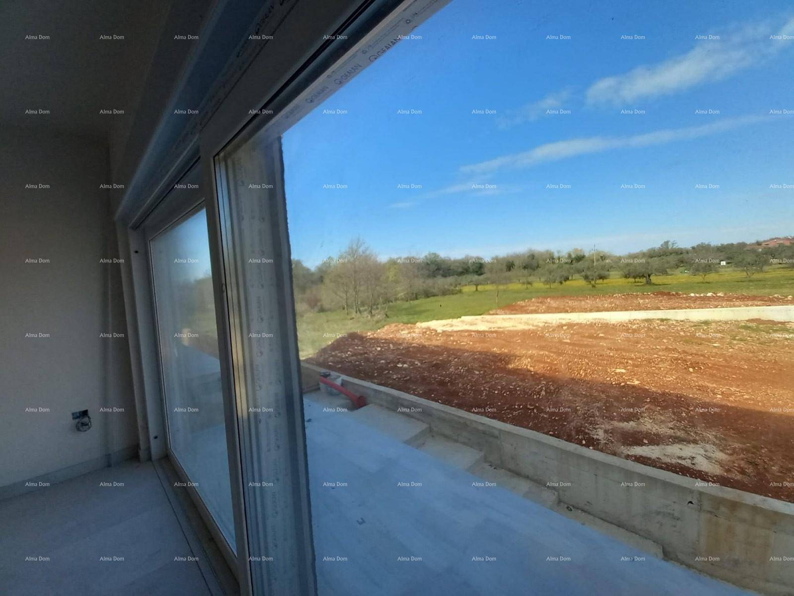 Große Schiebetür mit weitem Blick auf die unberührte Natur und den blauen Himmel.