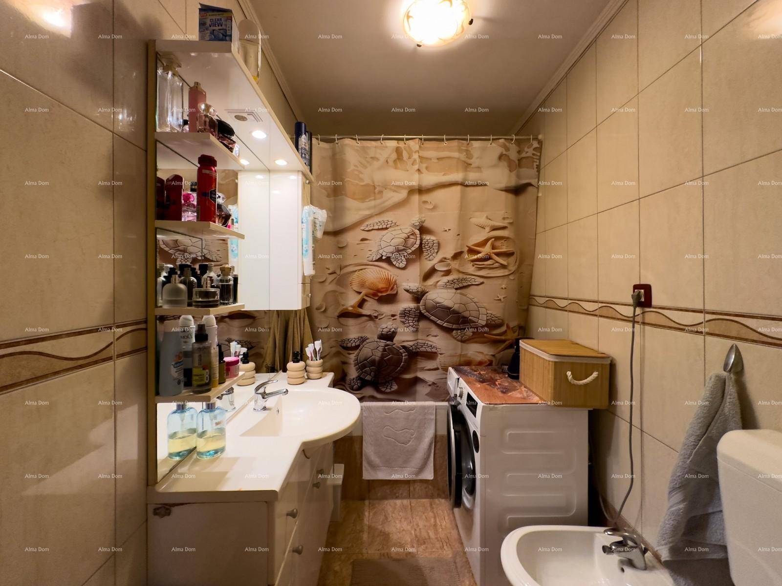 Badezimmer mit Badewanne, Waschmaschine, Bidet und Fliesen an Wänden und Boden.