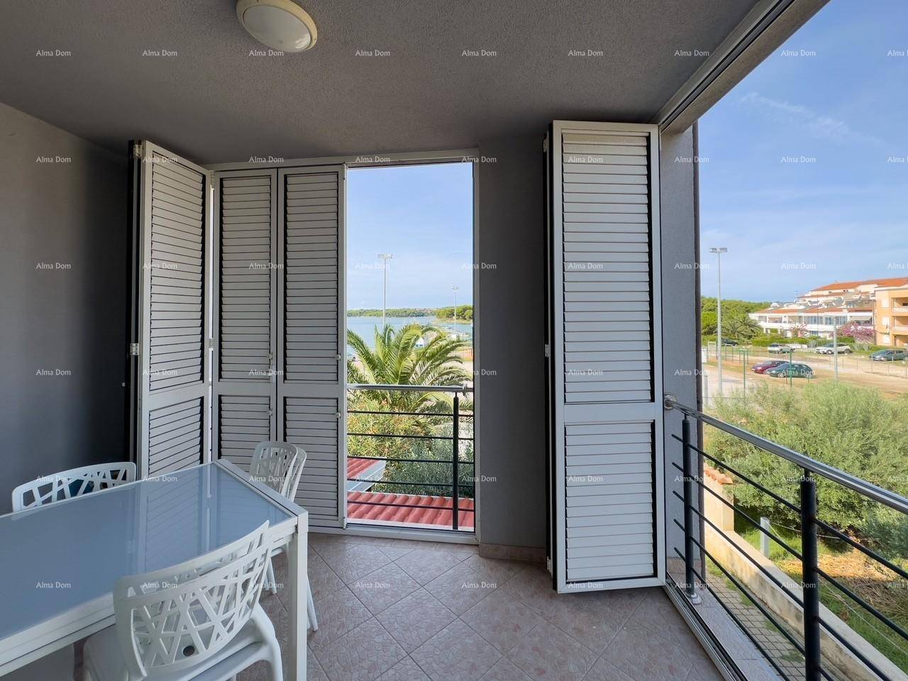 Möblierter Balkon mit Esstisch und Stühlen, bietet einen schönen Blick auf das Meer.