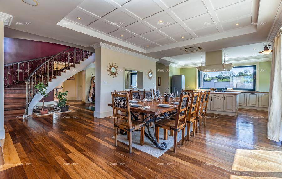 Heller offener Wohnbereich mit Küche, Essbereich und eleganter Wendeltreppe.