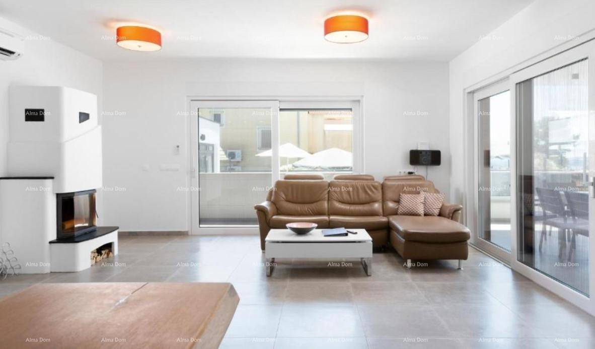Gemütliches Wohnzimmer mit braunem Ledersofa, Kamin und Zugang zu einem Außenbereich.
